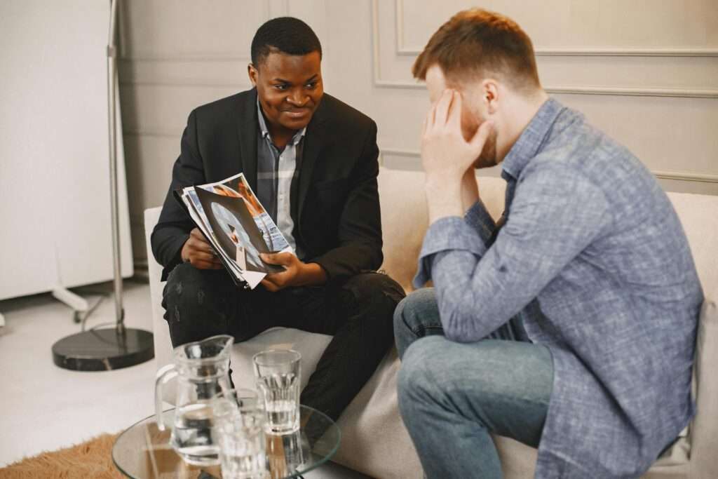 A therapist engaging with a client during a counseling session in an office environment.